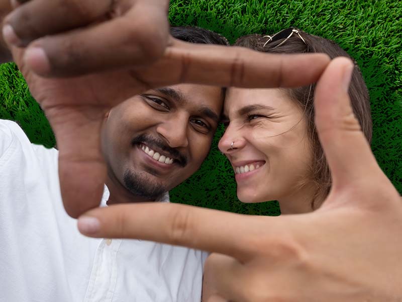Couple smiling on grass