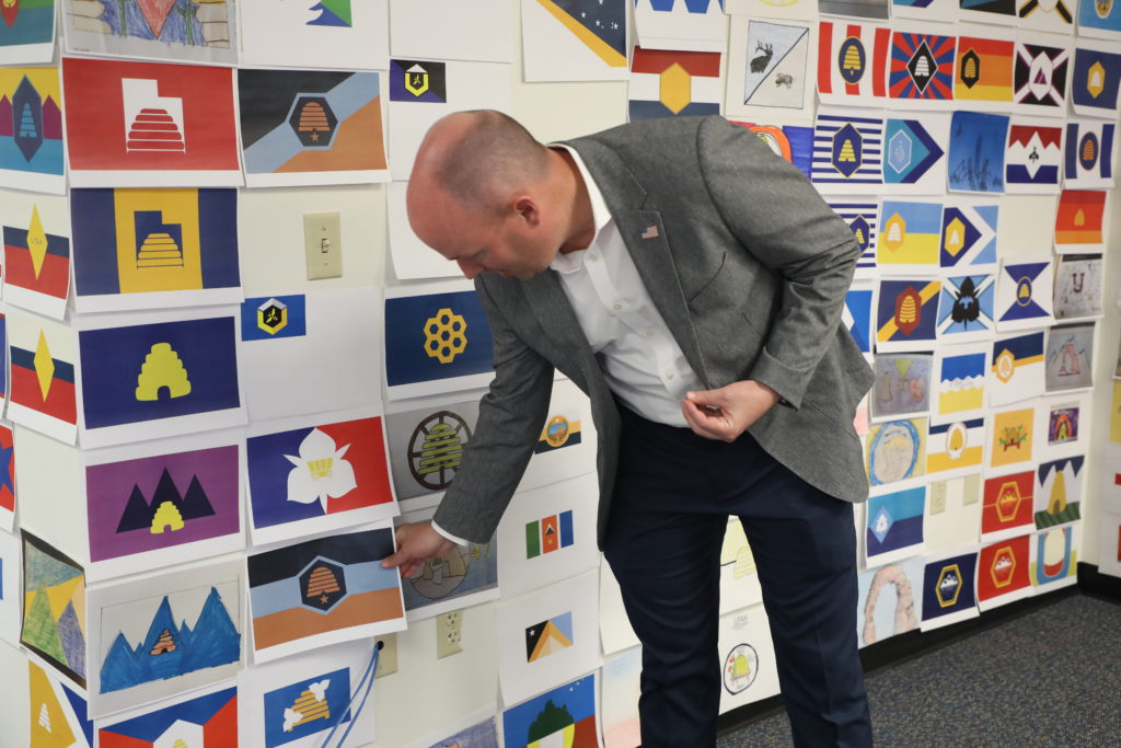 Governor Cox viewing flag submission wall